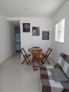 a living room with a wooden table and chairs at Espaço Brisa do Mar in Olinda