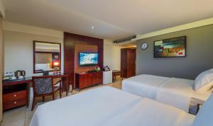 a hotel room with two beds and a desk at Boudl Al Shatea in Dammam +25 photos