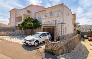 a small car parked in front of a house at 2 Bedroom Awesome Apartment In Pag in Pag +27 photos