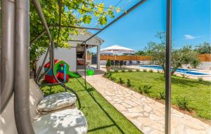 a view of a backyard with a playground at Beautiful Apartment In Donje Rastane in Donje Raštane +26 photos