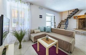 a living room with a couch and a table at Four-Bedroom Holiday Home Labin With Sea View 08 in Labin
