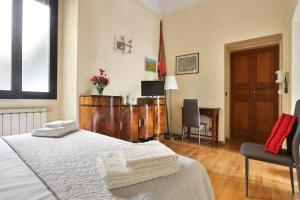 a bedroom with a bed with towels on it at Small Studio, Donatello, next to the Duomo of Florence in Florence