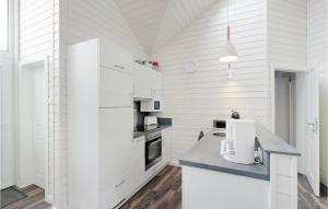 a kitchen with white walls and a ceiling at Cozy Home In Krems Iiwarderbrück in Göls