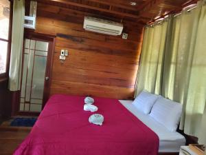 a bedroom with a bed with two towels on it at ภูริรักษ์ โฮมสเตย์ in Ban Pha Saeng Lang +32 photos