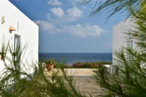 a view of the ocean from a white building at Glyfa Village in Drios