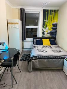 a bedroom with a bed and a desk and a chair at Neil2 in London