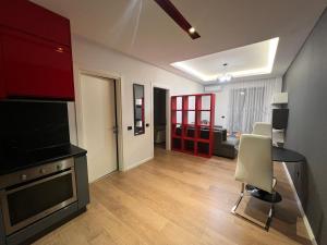 a living room with a television and a dining room at Downtown Grand Comfort in Tirana