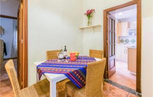 a dining room with a table and chairs and a kitchen at 2 Bedroom Lovely Apartment In Cordoba in Córdoba