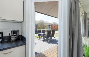 a sliding glass door leading to a patio with a table at 2 Bedroom Amazing Home In Süsel in Süsel