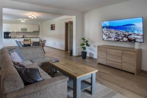 een woonkamer met een bank en een tafel bij Villa Sara Family Villa with Pool and Jacuzzi Imotski Makarska Region in Imotski