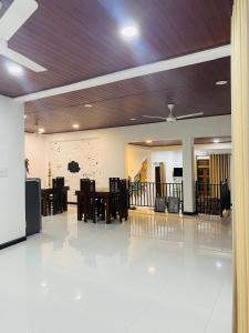 a large hall with a table and chairs in it at Enara Luxury Stay in Katugastota
