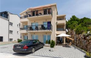 a car parked in front of a building at 3 Bedroom Nice Apartment In Komarna in Komarna