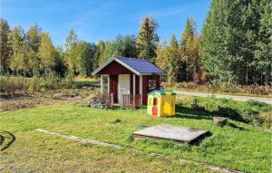 a smallshed in a grassy field with a wooden platform at 6 Bedroom Nice Apartment In Vallsta in Vallsta
