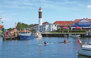 two people in kayaks in the water near a lighthouse at 1 Bedroom Lovely Apartment In Kirchdorf in Kirchdorf +10 photos