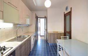 a kitchen with a sink and a blue tile floor at Amazing Apartment In Recco With Kitchen in Recco