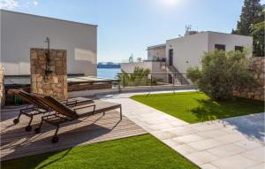 a bench on the deck of a house at 2 Bedroom Stunning Apartment In Omisalj in Omišalj