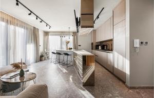 a kitchen and a living room with a table at Beautiful Home In Srima in Srima