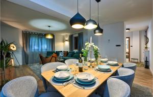 a dining table and chairs in a living room at Nice Home In Sedlarica With Sauna in Sedlarica