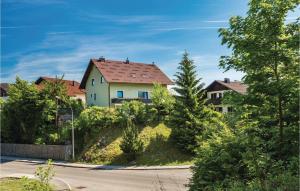 a house with a red roof on the side of a road at Awesome Apartment In Delnice With Wifi in Delnice