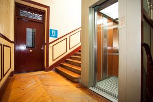 a hallway with a door and stairs in a building at Alhambra Suites in Madrid