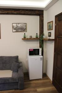 a living room with a couch and a microwave at Pálma Apartmanok Szálláshely Százhalombatta 3a in Százhalombatta +7 photos
