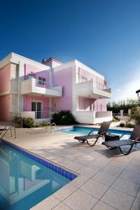 a house with a swimming pool in front of it at Kronos Villas in Kolymvari