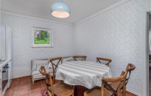 a dining room with a table and chairs at Cozy Home In Rab With House Sea View in Rab