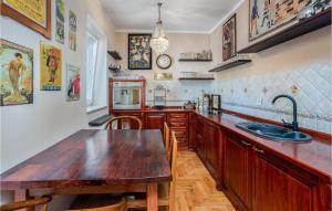 a kitchen with a wooden table and a sink at 6 Bedroom Lovely Home In Rab in Rab