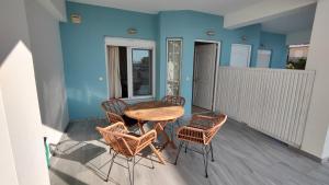 a small balcony with a table and chairs on it at Messinian Aura in Arkondikó