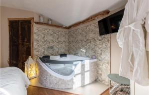 a bathroom with a tub in the corner of a room at Stunning Home In Capannori With Jacuzzi in Capannori