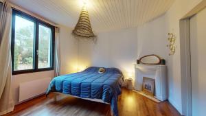 a bedroom with a bed in a room with a fireplace at La Cachette des Vagues in Les Sables-dʼOlonne +33 photos