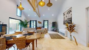 a living room with a table and chairs at La Cachette des Vagues in Les Sables-dʼOlonne