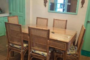 a dining room table with chairs and a mirror at Tiny house in city proper in Puerto Princesa City +3 photos
