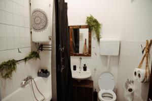 a bathroom with a toilet and a sink at Studio apartman Ars libri in Đakovo +37 photos