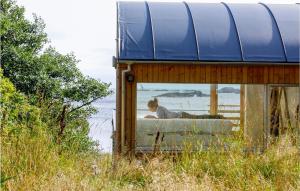 a man laying on a couch in a house at Awesome Home In Farsund With Wifi in Farsund +30 photos