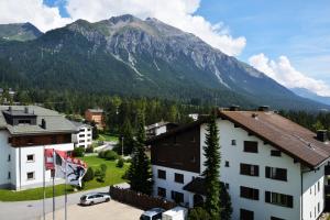 a view of a mountain from a building in a village at Ferienwohnungen Chesa Clois 24 Studios in Lenzerheide