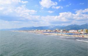 a beach with a bunch of umbrellas and buildings at 4 Bedroom Nice Home In Pietrasanta in Pietrasanta +20 photos