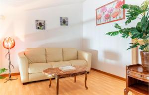 a living room with a couch and a table at Awesome Home In La Faute Sur Mer in La Faute-sur-Mer