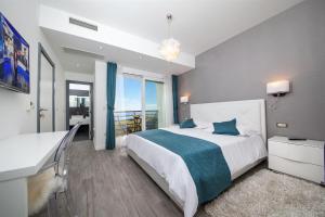 a bedroom with a large bed and a large window at Villa Red with pool and sea view in Makarska +16 photos