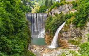 a waterfall on the side of a mountain at Beautiful Apartment In Lamon With Wifi in Lamon