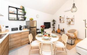 a kitchen and dining room with a table and chairs at 2 Bedroom Stunning Home In Nerezisca in Nerežišća