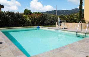 a swimming pool with two chairs next to it at Gorgeous Home In Capezzano Pianore in Capezzano Pianore,