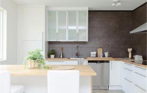 a kitchen with white cabinets and stainless steel appliances at Gorgeous Home In Lammhult in Lammhult