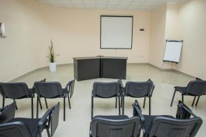a room with chairs and a table and a screen at Sin-Kom Hotel Garni in Pirot