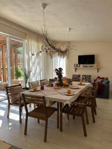 a dining table and chairs in a living room at Kuca Oste in Banja Luka