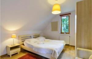 a bedroom with a white bed and a window at 3 Bedroom Lovely Home In Karpacz in Karpacz