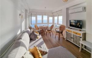a living room with a couch and a television at Lovely Apartment In Algarrobo-Costa in Algarrobo-Costa