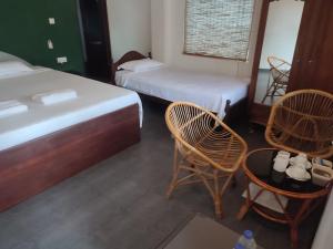 Postel nebo postele na pokoji v ubytování Sunil Garden Guesthouse
