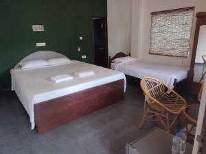 Postel nebo postele na pokoji v ubytování Sunil Garden Guesthouse