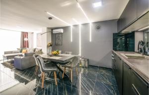 a kitchen and living room with a table and chairs at Lovely Home In Novo Zvecevo With Sauna in Novo Zvecevo +25 photos